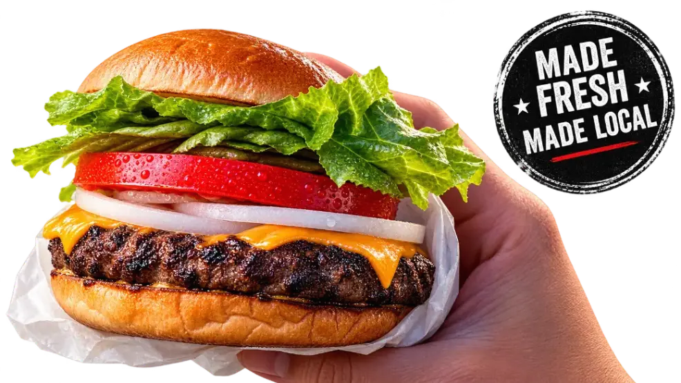 Fresh local burger with tomato, lettuce, onion, and cheese at Floyd Xpress Market deli